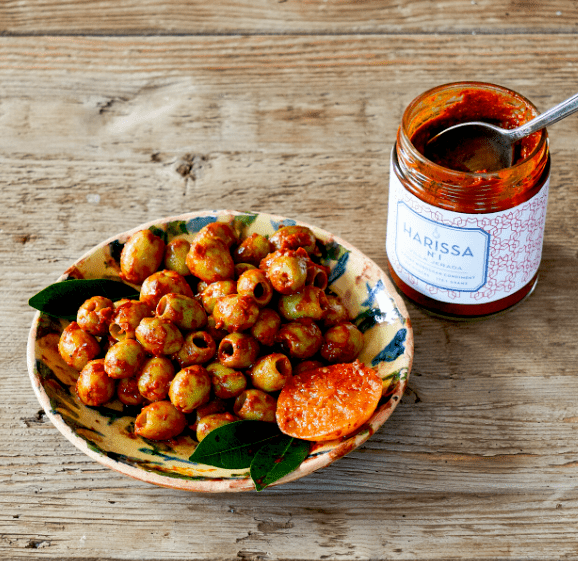 Originating in Tunisia before catching on in Libya, Algeria, Morocco and eventually the rest of the world, harissa is made with dried chilies, tomato or roasted pepper and a blend of spices that varies depending on who's making it.